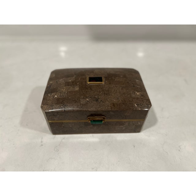 A vintage light brown tessellated stone box mounted with brass banding. The front hinge is adorned by a rectangular piece...