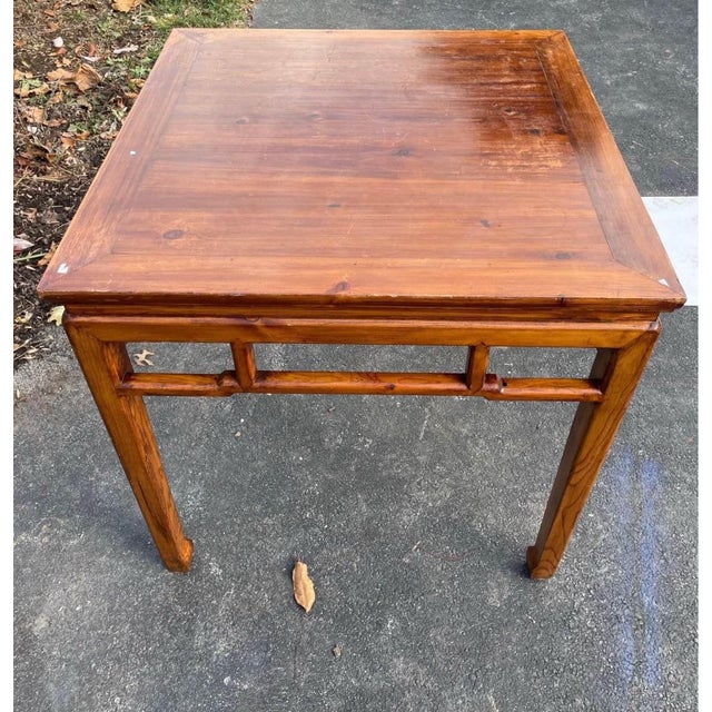 A beautifully crafted Chinese elm square table in the classical Ming style, dating to the early 20th century. This elegant...