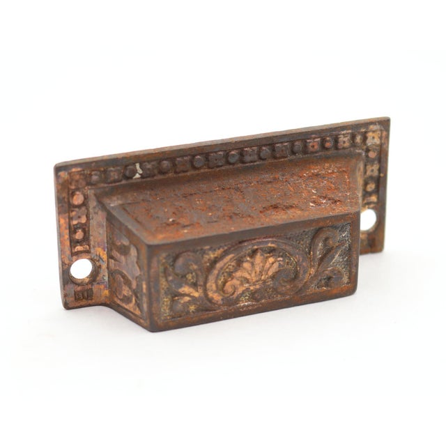 Victorian style cast iron drawer bin pulls with a brass finish. The original mounting screws are not available. Good...