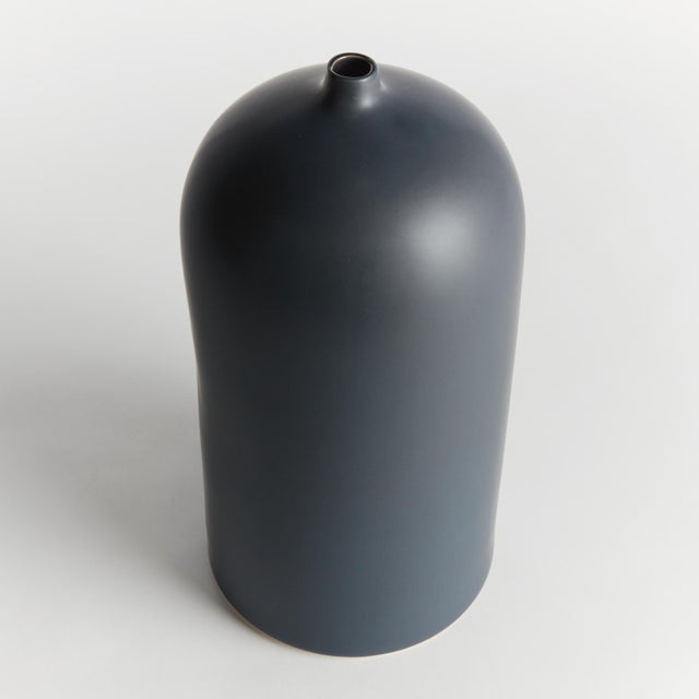 Simple in form with a modern aesthetic, this vase is the definition of less is more. Finished in a smooth dark navy, matte...