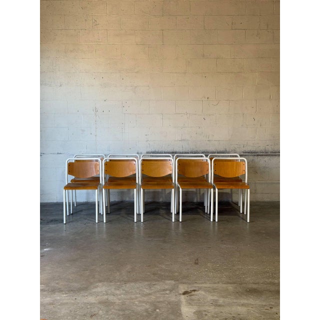 This set of ten stacking chairs features bent tubular frames and curved wooden backrests. Their lightweight space-saving...