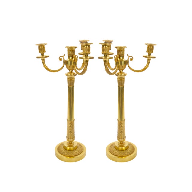 An elegant pair of antique late 19th century Italian gilt bronze four-light candelabra, beautifully crafted in the...