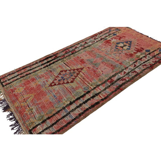 Hand-knotted in wool circa 1950-1960, this 4x8 vintage Moroccan rug with polychromatic geometric patterns and medallions,...
