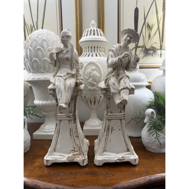 Striking pair of tall seated Asian figures from Chelsea House, made in Italy. Lightly distressed/aged finish with crackle...