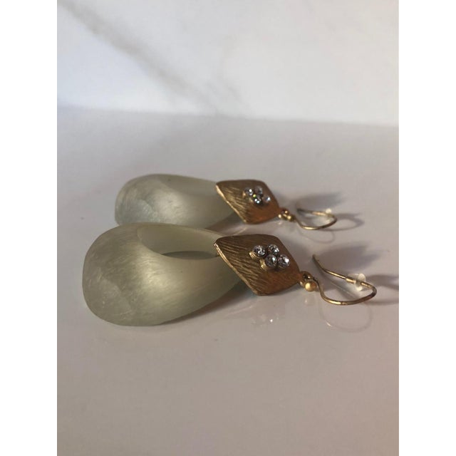 These eye-catching vintage Matte Gold Tone Frosted Cream Lucite Door Knocker Earrings are so unique and fabulous with...