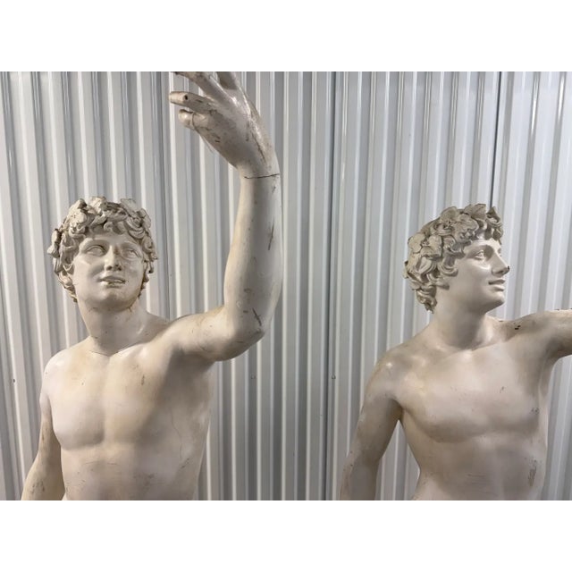 An impressive matching pair of monumental classical Bacchus sculptures, each standing an impressive 78 inches tall....