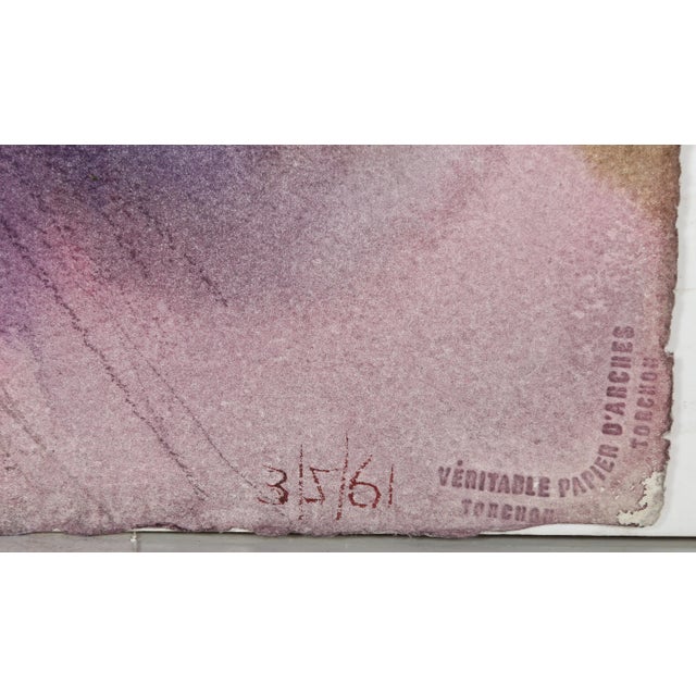 This sumptuous portrait of a woman with cropped, curly blonde hair is imbued with luxury and elegance. As she lifts her...