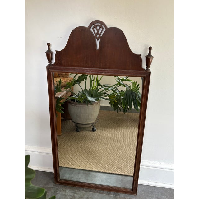 Antique Federal Style tall wall mirror flanked by a pair of traditional turned-wood finials and a carved openwork design....