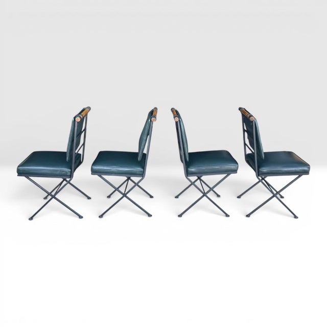 This striking set of four vintage dining chairs, designed in the style of Cleo Baldon, brings bold architectural presence...