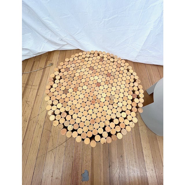 Kenneth Cobonpue “Chiquita” stool featuring a sculptural cylindrical form with a natural wood top and a sleek metal base...