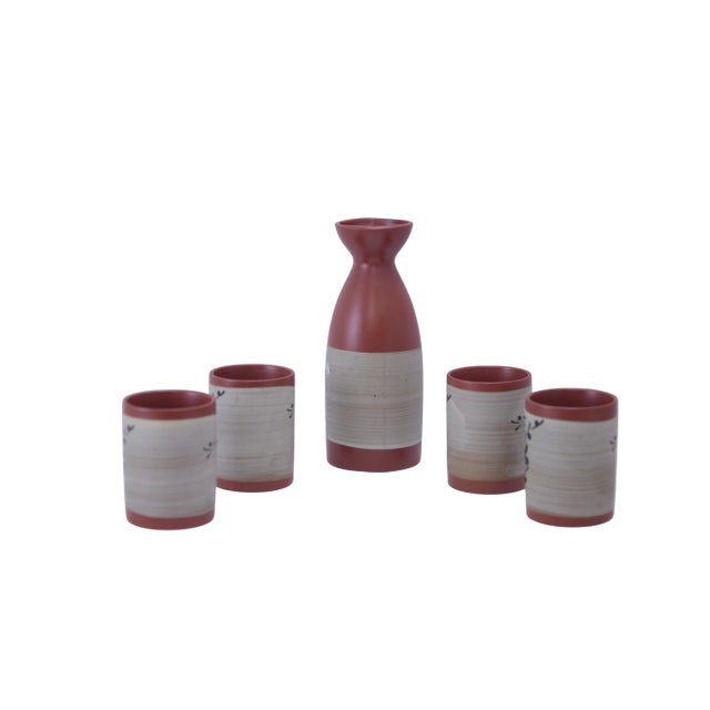 Vintage hand painted decorated terracotta glaze ceramic five piece sake set adorned with delicate cherry plum blossoms....