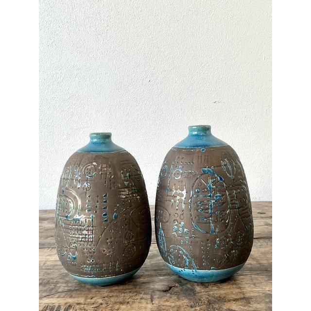 This exceptional pair of vintage studio pottery vases captures the raw, expressive spirit of the Brutalist and Mid-Century...