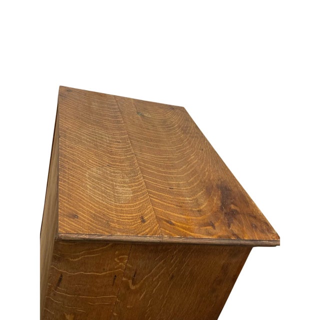 A rare and finely crafted quarter-sawn oak sheet music cabinet, dating from the early 1900s, showcasing the exquisite...
