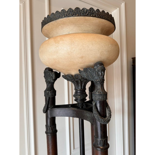 This pair of vintage neoclassical torchiere floor lamps is a stunning addition to any collection. The lamps stand at an...