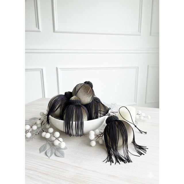 A refined and dramatic set of six handcrafted velvet ornaments. Each one is wrapped in muted green velvet and finished...