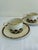 A sophisticated set of four vintage cup and saucer sets by Pickard in the Ensemble Burgundy pattern. Hand decorated in the...