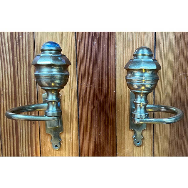 Unusually large Federal brass jamb hooks used to hold fire tools on fireplace. The brackets are attached to the mantel and...