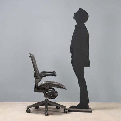 Office chair made of plastic material with a black finish, featuring the manufacturer's logo. This piece is attributed to...