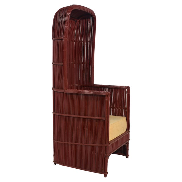 A striking vintage canopy chair in rattan painted a beautiful vermilion red. The seat cushion is in need of replacement....