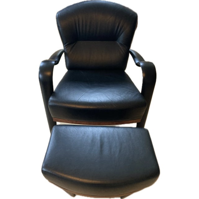 PACE COLLECTION Style Black Leather chair and ottoman crafted in rosewood and ebony. Unique curved arm design and modern...