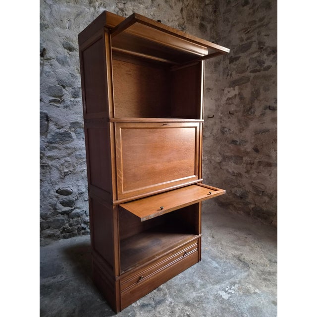 A French modular secretary cabinet dating from the 1950s, manufactured by Bibliothèque MD (Martin Dupuis). The cabinet has...