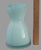Crafted with meticulous attention to detail, this vintage Aqua vase is a striking example of hand-blown art glass. Its...