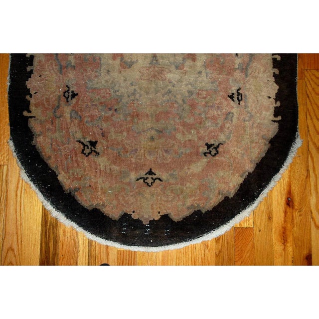 Beautiful oval Art Deco Chinese rug in pink, beige, sky blue and black shades. The rug is from the beginning of 20th...