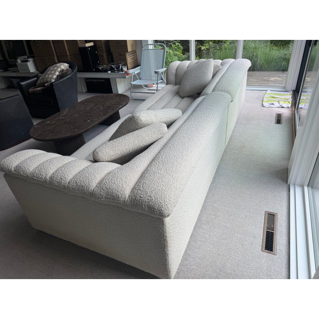 Inspired by 1970s conversation pits, this generously-sized sofa with extra-plush channel tufting, deep seats, and wide...