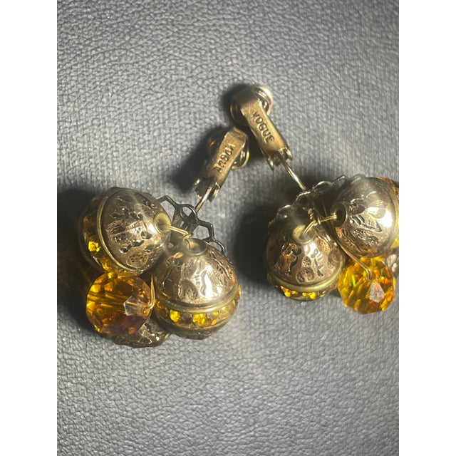 These earrings exemplify the golden age of American costume jewelry from the 1950s-1960s, when Vogue Jewelry created...