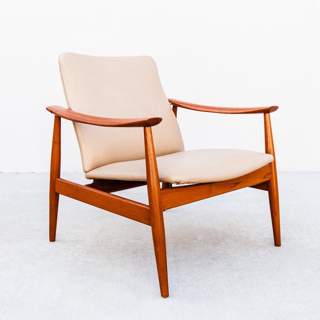 A newly restored Model 138 easy chair by Finn Juhl in old-growth teak and textured Edelman Modernaya leather, produced in...