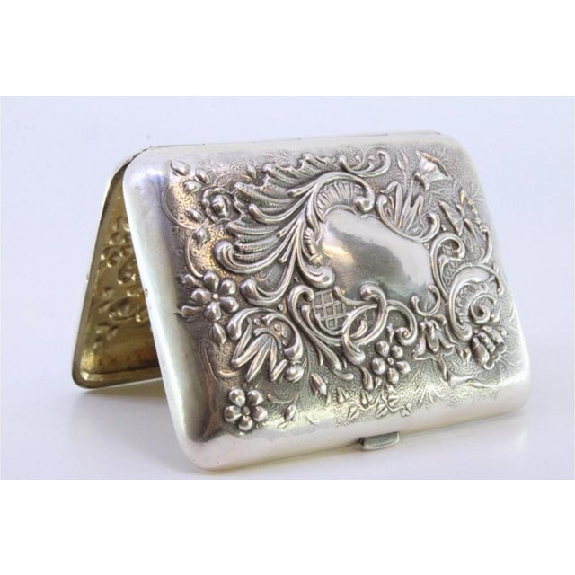 Silver Cigarette Case with Reliefs and Monogram, in Very Good conditions. Designed 1890 to 1919 This piece has an...
