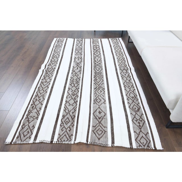 Vintage Turkish Hand-Knotted vintage rug is a semi-Vintage kilim area rug.'70s Eastern region of Turkey's unique rug is...