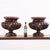Here is a gorgeous pair of enameled garden urns featuring lion-mask ringed handles. The deep understated reddish-brown...