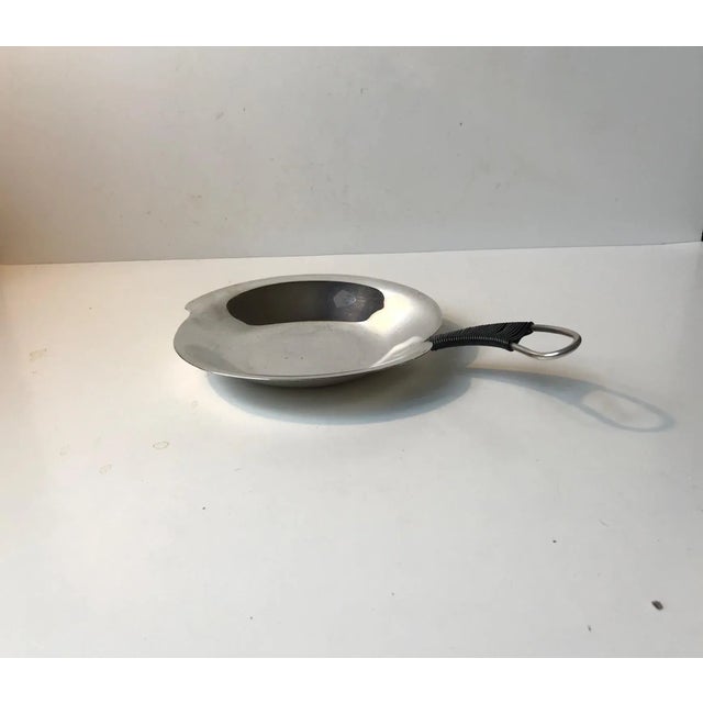 Small silver plated dish with decorative black caned handle. Designed and manufactured in Denmark during the 1940s or 50s....
