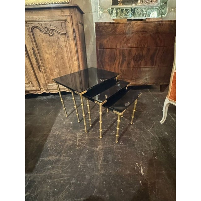 This set of Italian Jansen Manner nesting tables features a sleek design with a black lacquer finish, adding an elegant...