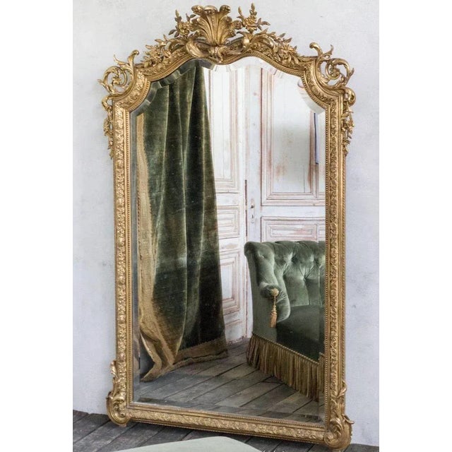 Large and impressive 19th century French Baroque style beveled mirror with an elaborately hand-carved gilt frame. Very...