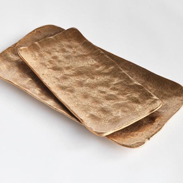 Modern, rectangle forms and rounded edges make this pair of cast aluminum trays unique. Line with a collection of candles,...