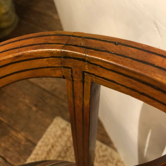 Elegant and unusual form in a 19th century fruitwood French chair having rounded shape and open back with 3 gorgeous...