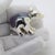 This vintage silver animal sculpture depicts a bear cub miniature, crafted as a desktop accent, vitrine display piece, or...