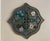 A vintage Gothic Revival wall plaque in a quatrefoil form, featuring sculpted floral reliefs arranged around the cardinal...