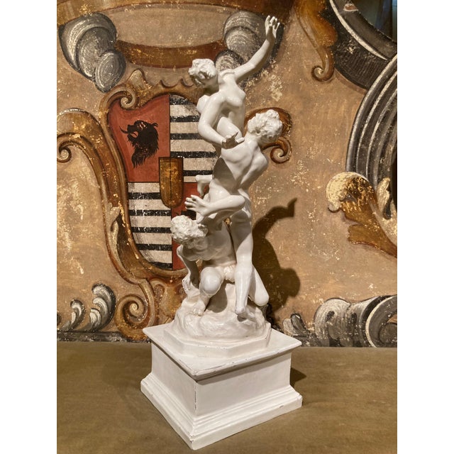 This compelling italian 19th century white glazed porcelain sculpture depicts ‘the rape of the sabines’, after a...