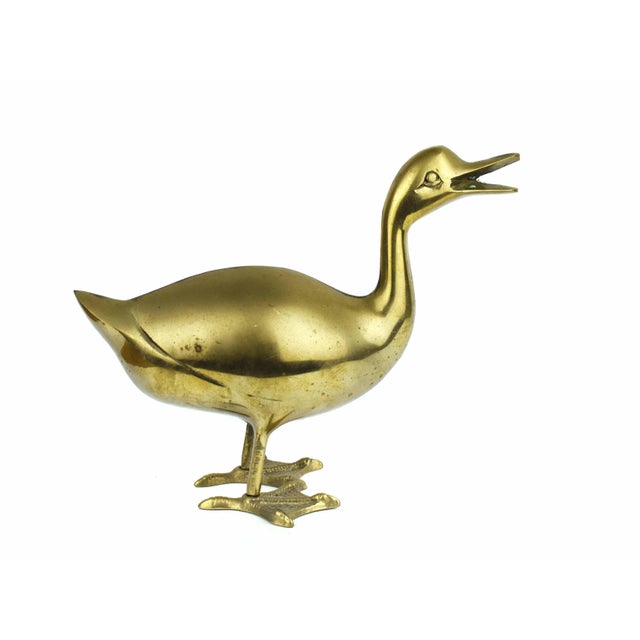 This charming vintage brass duck figurine captures a playful sense of character with its open-billed, "quacking" pose....