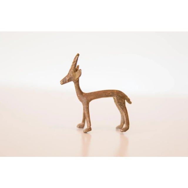 :: Vintage handmade copper casting of a gazelle with dusty patina. Circa mid 20th century and possibly older, this piece...