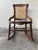 Vintage Victorian rocking chair featuring a dark wood frame, a woven cane back, and a cane seat in excellent condition....