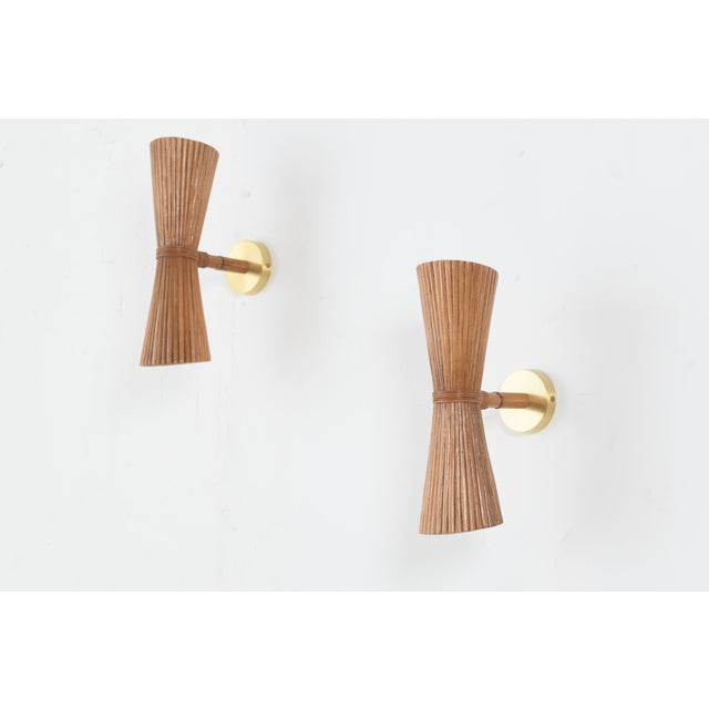 lluminate your space with understated elegance through this striking up-down wall light, where natural rattan reed meets...