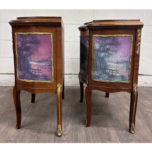 This is a gorgeous pair of vintage French Louis XV-style nightstands or bedside cabinets featuring decorative romantic...