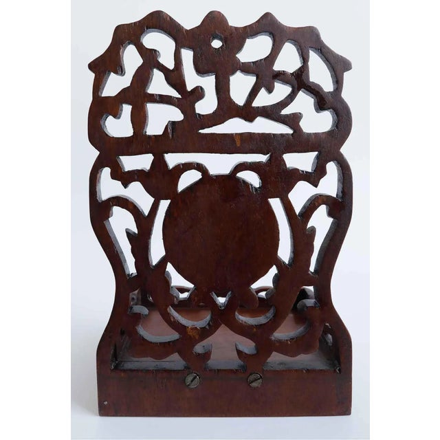Pair of vintage wall pockets detailed with intricate openwork floral designs and circular carved green jade inserts.
