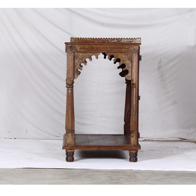 Antique Indian Teakwood Mandir or Home Temple, with carved and fluted columns, boldly scalloped arch carvings, a carved...