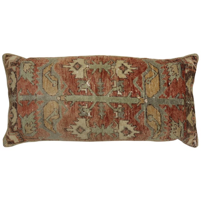 Pillow made from an early 20th century Turkish rug in a soft colors with a geometric motif. zipper closure and poly-fill...