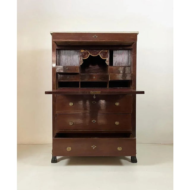 Elegant folding cabinet from the imperial era, with mahogany feather workmanship. It has 5 small drawers inside and two...